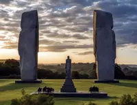 A split monolith with a smaller statue in front of it